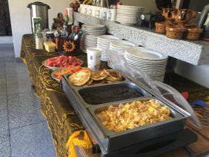 a buffet of food on a table with plates at Hotel Coatlicue in San Juan Teotihuacán