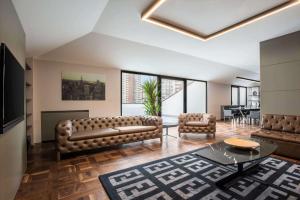 a living room with a couch and a table at TRYP by Wyndham Ankara Oran in Ankara