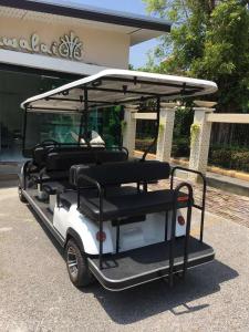 a golf cart parked in front of a building at Achawalai Residence Village By Song in Jomtien Beach