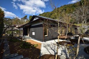 a house with a mountain in the background at Aoi Suites at Nanzenji Modern & Traditional Japanese Style in Kyoto