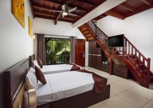 a bedroom with a bed and a staircase at Le Palmiste Resort & Spa in Trou aux Biches