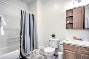 a bathroom with a toilet and a sink and a shower at Capitol Hill Luxury Apartments in Seattle +26 photos
