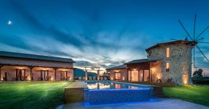 an image of a house with a windmill at Ageras Santa Marina in Lefkada Town