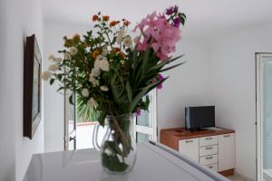 a vase filled with flowers sitting on a table at Villaggio Passo Dell'Arciprete in Vieste