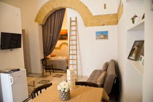 a living room with a couch and a table at La Culla di Adeodata in Marsala