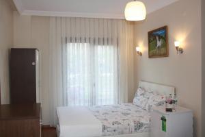 A bed or beds in a room at Sapphire Hotel