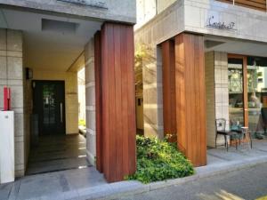 a building with wooden columns on the side of it at Alphabed TakamatsuKawaramachi 501 / Vacation STAY 21604 in Takamatsu