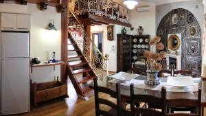 a kitchen and dining room with a table and a staircase at La Casa de los Templarios in Puebla de Alcocer