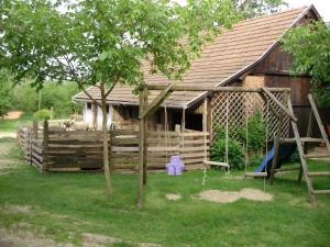 a house with a fence with animals in it at Ferencz Porta in Szalafő