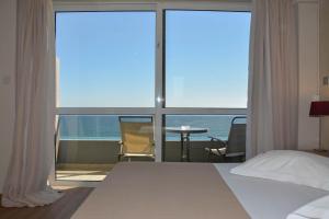 Voodi või voodid majutusasutuse Scorpios Sea Side Hotel toas