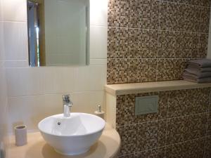 a bathroom with a white sink and a mirror at Marigolds in Sigulda