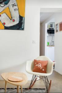 a white chair with a pillow on it next to a table at Nuits étoilées Lourmarin in Lourmarin