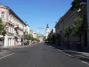 an empty street in a city with buildings at Downtown apartment in Vilnius str. in Vilnius