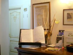 a book sitting on top of a wooden table at Affittacamere Le camerine di Silvia 2 in Siena