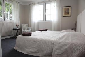 a bedroom with a bed, desk, and window at Gure Lana in Saint-Jean-Pied-de-Port