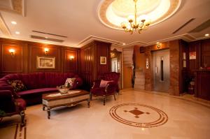 a living room with a red couch and chairs at Emine Sultan Hotel in Istanbul