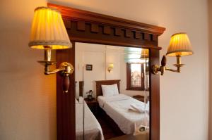 a hotel room with a bed and a mirror at Emine Sultan Hotel in Istanbul