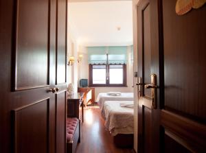 a bedroom with a bed and a window and a door at Emine Sultan Hotel in Istanbul