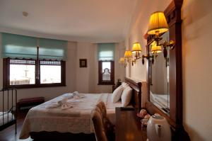 a bedroom with a bed and a large mirror at Emine Sultan Hotel in Istanbul