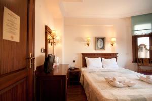 a hotel room with a bed and a television at Emine Sultan Hotel in Istanbul