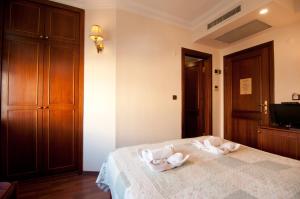a bedroom with a bed with two towels on it at Emine Sultan Hotel in Istanbul