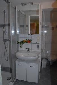 a white bathroom with a sink and a shower at Laterndl-Wirt in Sankt Veit im Pongau +41 photos