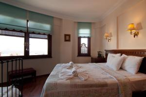 a bedroom with a bed with a towel on it at Emine Sultan Hotel in Istanbul