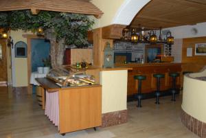 a restaurant with a counter and a bar at Laterndl-Wirt in Sankt Veit im Pongau