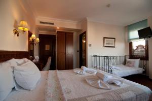 a bedroom with a bed with two towels on it at Emine Sultan Hotel in Istanbul