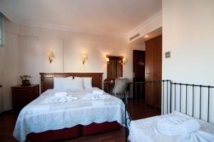 a bedroom with a bed with towels on it at Emine Sultan Hotel in Istanbul