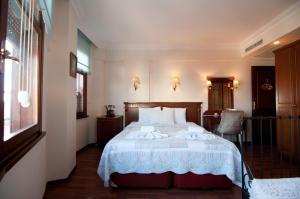 a bedroom with a bed and a table and a chair at Emine Sultan Hotel in Istanbul
