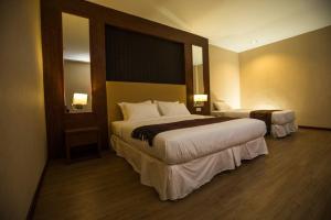Postel nebo postele na pokoji v ubytování Hotel Pen Mutiara