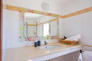 a bathroom with a sink and a mirror at Experience Il Paesino in Licodia Eubea +89 photos