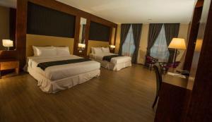 Postel nebo postele na pokoji v ubytování Hotel Pen Mutiara