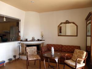 a living room with a couch and a fireplace at Sea Front two bedroom House in Lesvos in Tavari