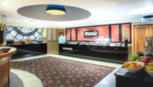 a large room with a kitchen with fruits on a table at Riu Plaza The Gresham Dublin in Dublin