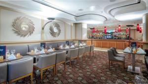 a dining room with tables and chairs and a bar at Riu Plaza The Gresham Dublin in Dublin