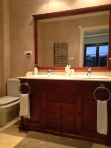łazienka z umywalką, lustrem i toaletą w obiekcie Marbella, Los Arqueros Golf & Country Club, Sleeps 7 plus 1 child w Marbelli