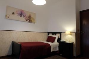 Postel nebo postele na pokoji v ubytování Hotel Villa Nettuno