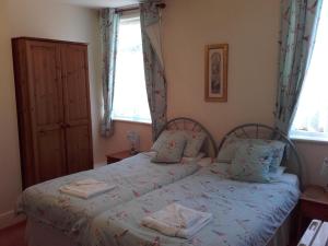 A bed or beds in a room at Clumber House Hotel