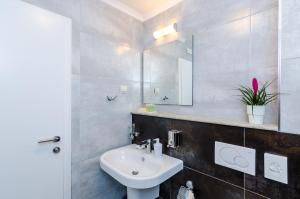 a bathroom with a sink and a mirror at Villa Flores in Dubrovnik +20 photos