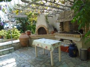 an outdoor kitchen with a pizza oven in a backyard at Sea Front two bedroom House in Lesvos in Tavari