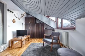 a living room with a desk and a staircase at Rezident Predeal in Predeal