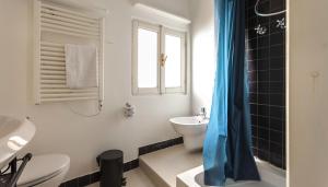 a bathroom with a sink and a toilet and a window at Italianway - Ripa di Porta Ticinese 17 in Milan