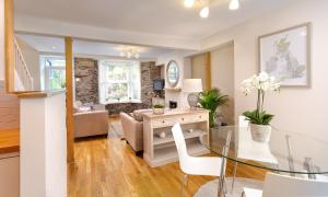 a dining room and living room with a glass table at Pottery Gate, Bowness-on-Windermere in Bowness-on-Windermere