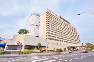 a large building on the corner of a street at The Galadari Hotel in Colombo