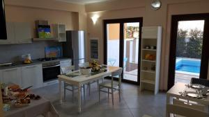 a kitchen with a table and a dining room at L'AURORA in Piedimonte Etneo