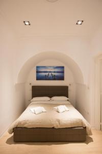 a bedroom with a large bed in a room at Pausilya by Dimorra in Naples