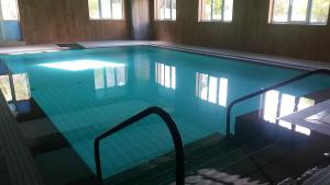 an empty swimming pool with a hand rail in it at Balneario Casa Pallotti in Carranza