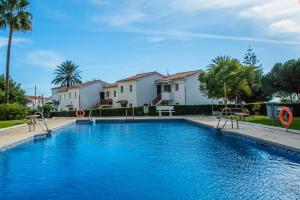 a swimming pool in a yard with houses and trees at Esmeralda, Pet Friendly, Sea View, Wifi, Near the Beach in La Cala de Mijas